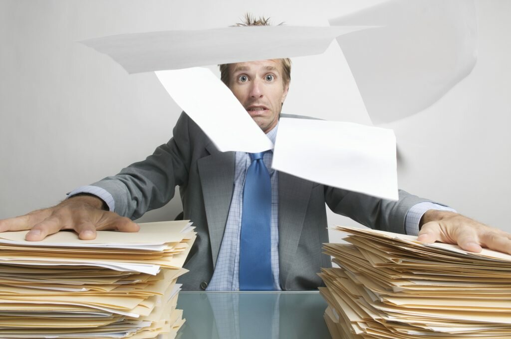 Office Worker Holds On to his Paperwork